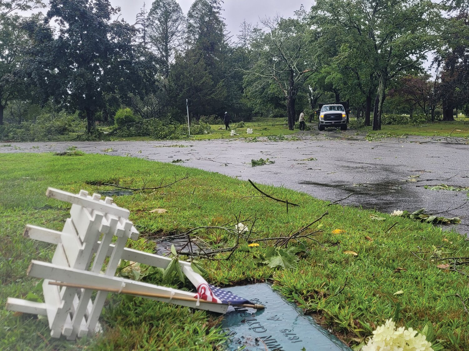 DIRECT HIT: Highland Memorial Park Cemetery in Johnston seems to have taken a direct hit by this morning's tornado. A path of destruction: fallen trees, scattered planters, graves unearthed and huge trees toppled.